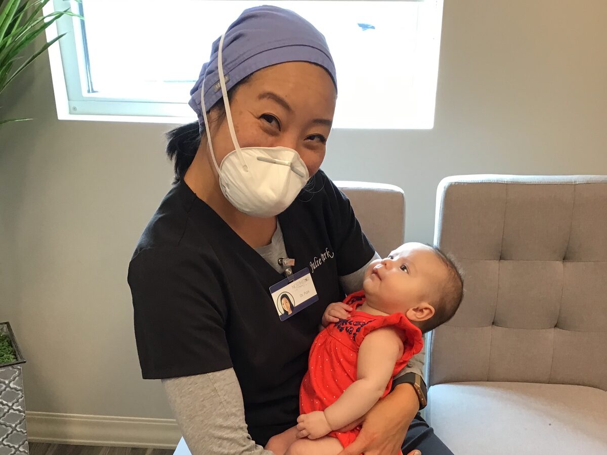 Dr. Julie Park holding an infant patient at Northstar Lip and Tongue Tie Center
